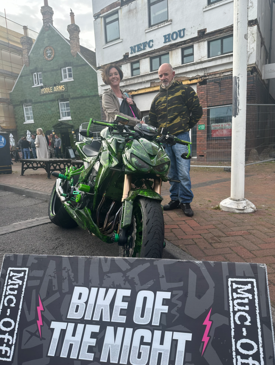 Bike night winner with their boke and the judge